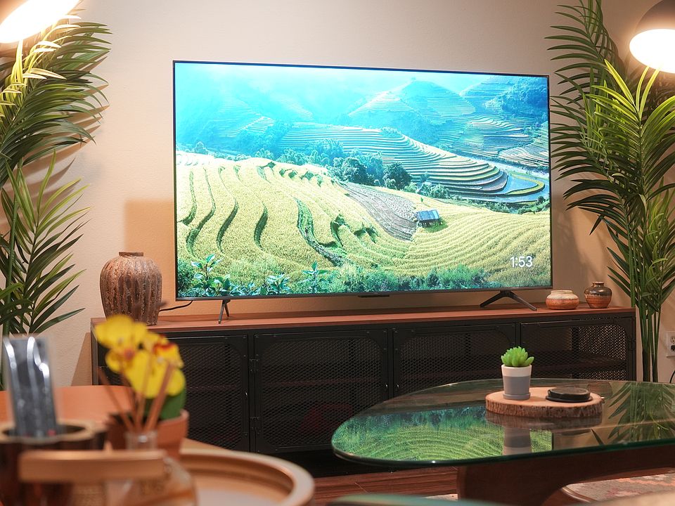 Living Room comes with a 65" TV along with leather sofa and an Herman Miller inspired glass coffee table