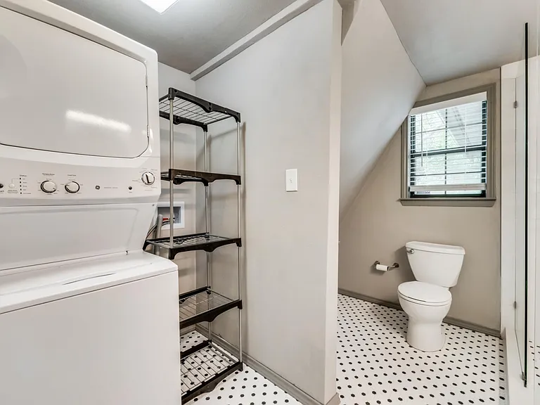 Stacked washer/dryer located in secondary bathroom