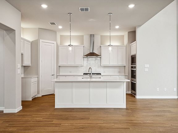 Kitchen in the Da Vinci II home plan by Trophy Signature Homes - REPRESENTATIVE PHOTO