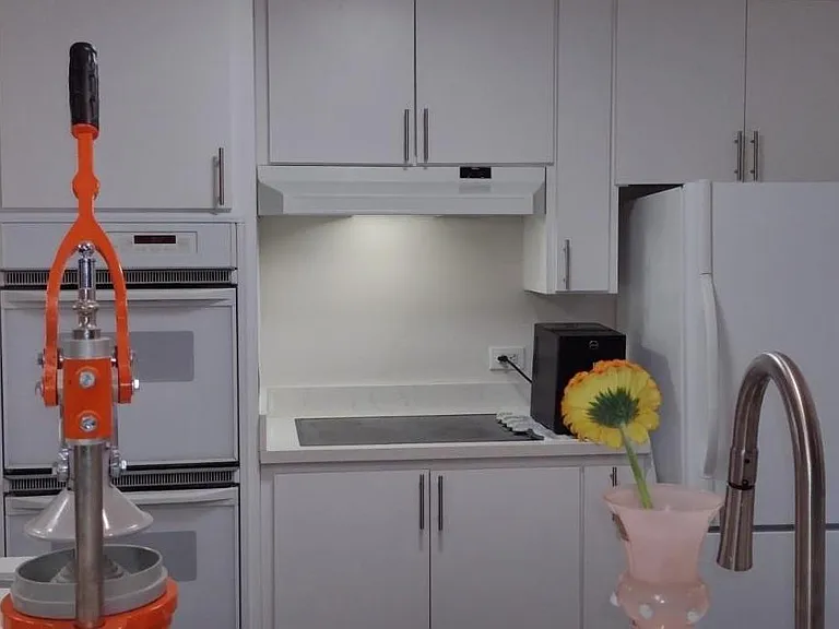 Fully restored and update kitchen: Doug fir cabinets, quartz counters, deep sink, electric 4 burner glass stove top, double kitchen-aid oven, fridge, disposer, breakfast bar with pendant lighting