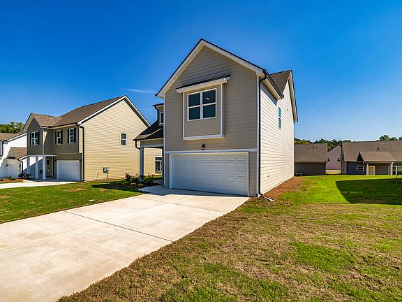 Admire the Bradford Craftsman from every angle! This side profile highlights the stunning architectural design, seamless rooflines, and thoughtful detailing that make this home a standout in both style and structure.