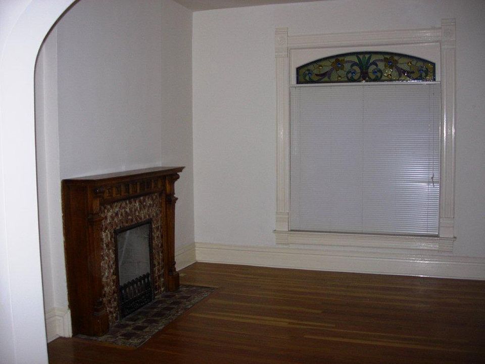 living room fireplace (not functional) and stained glass win