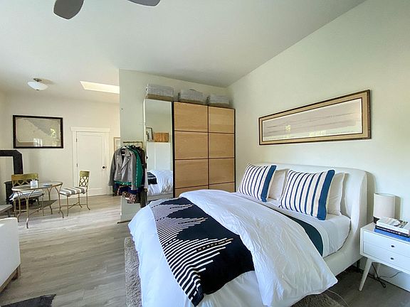 A half wall divides kitchen and bedroom with an area for dining in between