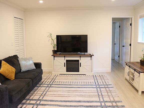 Comfortable and spaciaous living room. The TV stand has an electric fireplace.