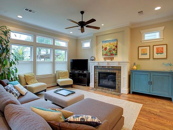 Den from previously built home has wall of windows looking onto oversized backyard