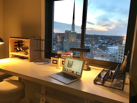 Large built in work desk in living room with gorgeous western view.