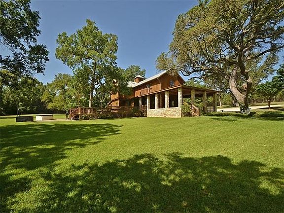There are large trees that dot the beautiful landscape of this property.