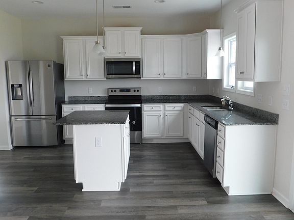 DESIGNER WHITCH KITCHEN WITH GRANITE AND STAINLESS STEEL APPLIANCES AND LVP FLORRING