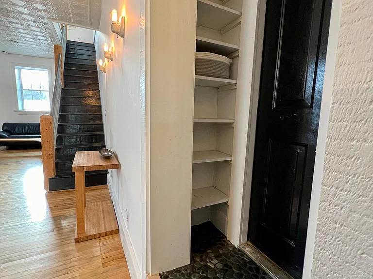 Pebble-tile pantry floor, shelving.