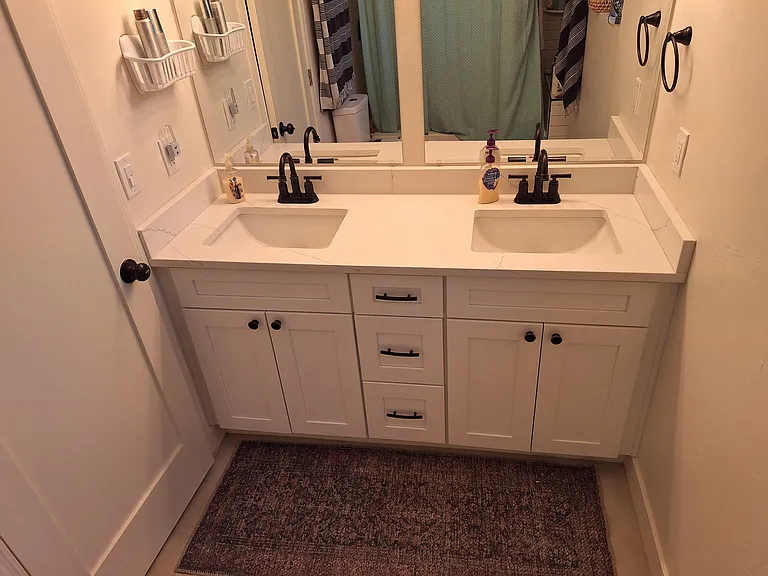 Bathroom includes double vanity and tub