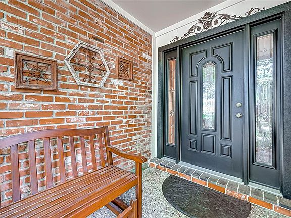 An inviting front porch greets friends and family. Bench remains!