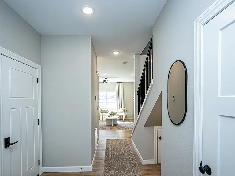 Entryway with Garage entrance on left and Half Bath on right