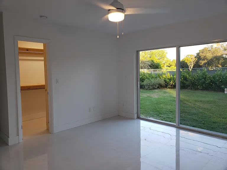 Another view of the master bedroom, master closet and sliding glass doors out to the private backyard. Since this was taken the privacy hedge has grown to the height of the house.