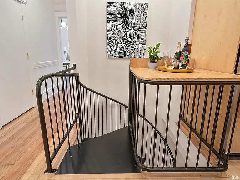Spiral staircase down to primary bedroom, bathroom & office space