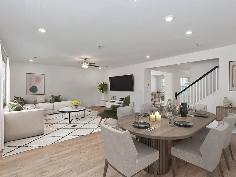 Living room with large couch, accent chairs, and windows.