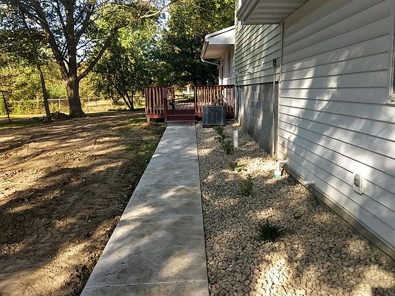 SIDEWALK TO THE DECK AND LANDSCAPING.