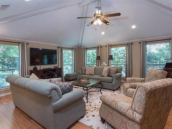 Windows on 2 sides of family room view the creek.