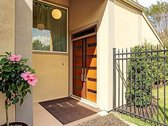 New custom front doors draw you into this beautiful home