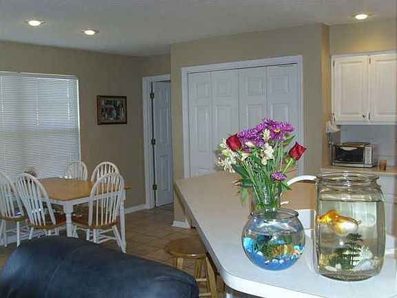 Kitchen and breakfast nook leading to master on right and sc