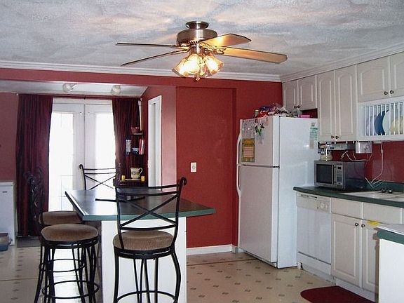 Redone Kitchen with Island and Doors to Deck