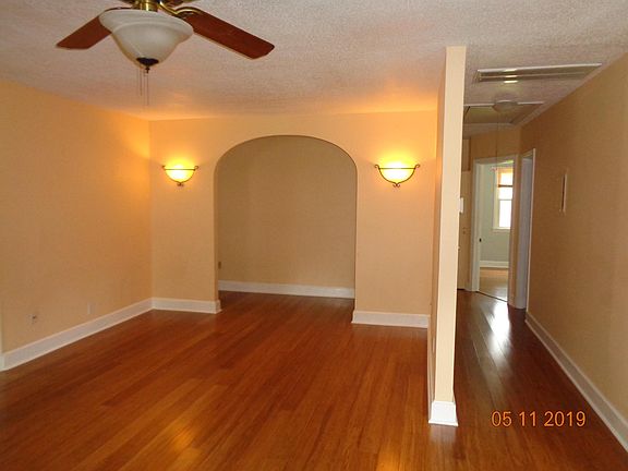 Living Room with bamboo flooring, hallway to 2nd bedroom and bathroom. Master suite is behind the arch to the left.