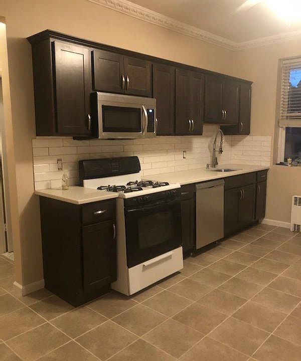 New cabinets, subway tile backsplash, ceramic tile floor