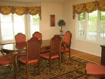 Lots of sunlight in the Dining room...bay window, wood floor.  This room may also be used for a formal living room.