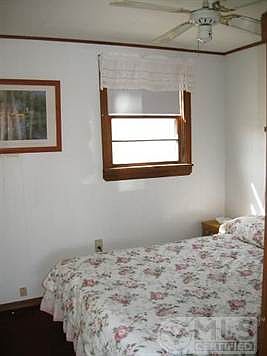Bedroom has a built in closet and ceiling fan.