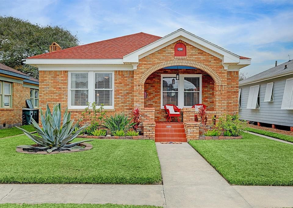 Circa 1932, one story brick bungalow with covered front porch. Driveway to two car garage on the right.