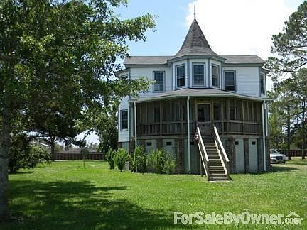 House as seen from road Hwy 45 to ferry
						:
						Nice trees, well maintained grounds and repaved driveway located on the right