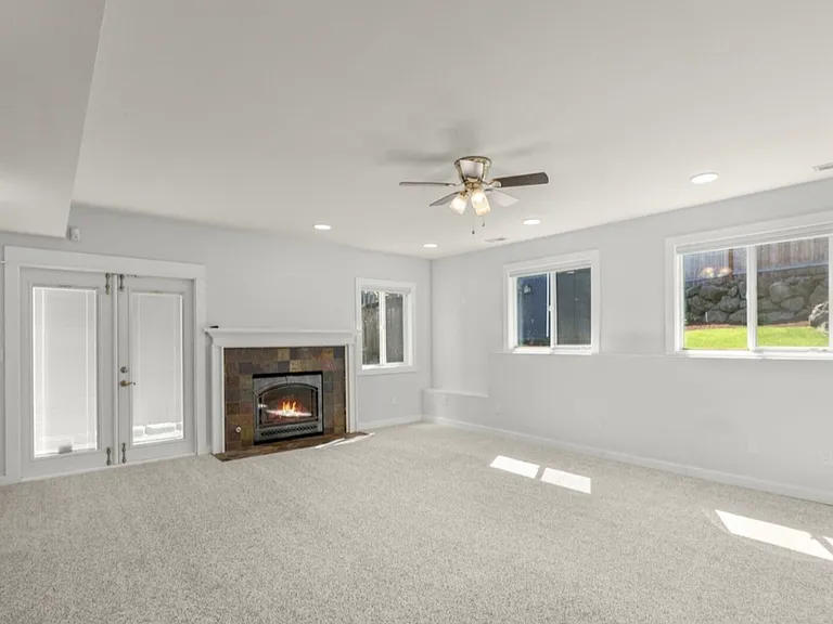 Downstairs family room. French door leads to fully landscaped backyard