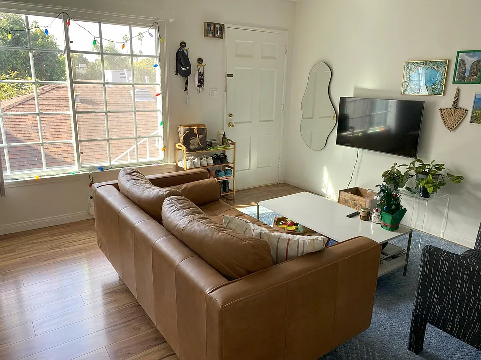 Living room (NOTE: Apt 4 has sliding door windows as seen on the deck - this photo is of a similar apt with the same layout)