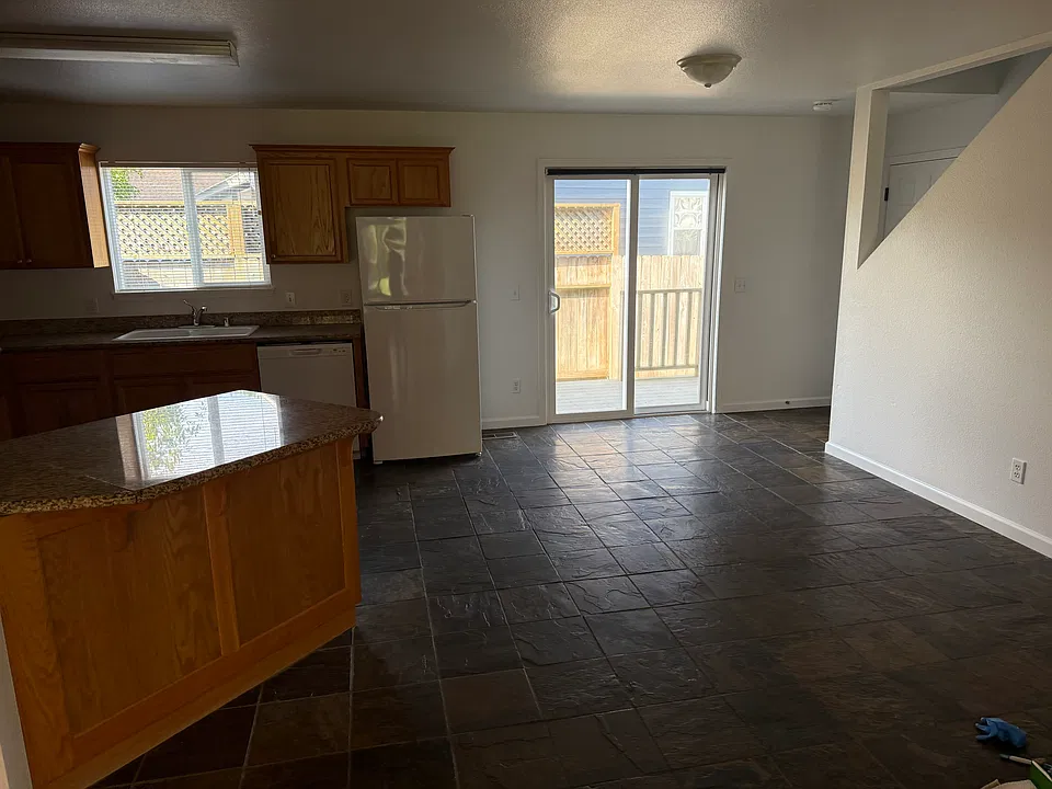Kitchen/dining areas, leading to small outdoor space with deck
