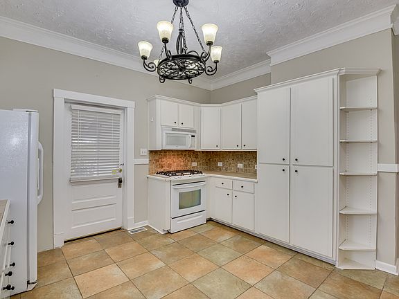Big kitchen, tiled floor and backsplash, plenty of storage