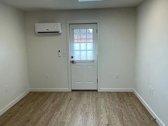 Living room with skylight. Door to side yard. Mini-split heatpump for heating/cooling