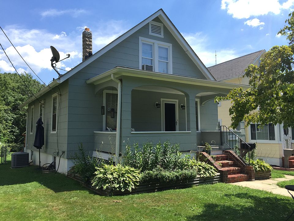 Newly painted cape cod with landscaping
