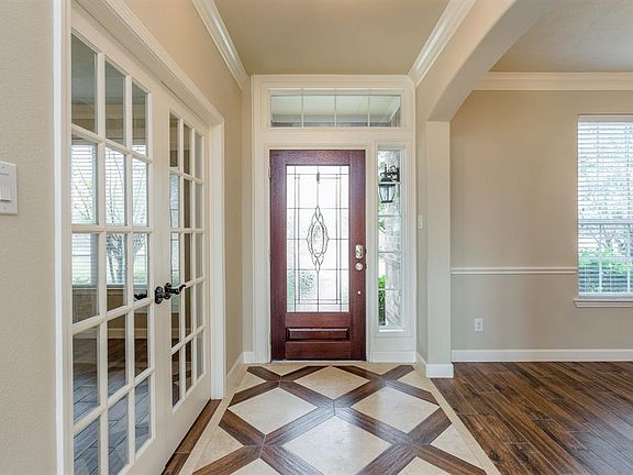 Upon entering you are greeted with a light and bright entry with high ceilings, detailed tile and wood floors and views in to the formal dining room and study.