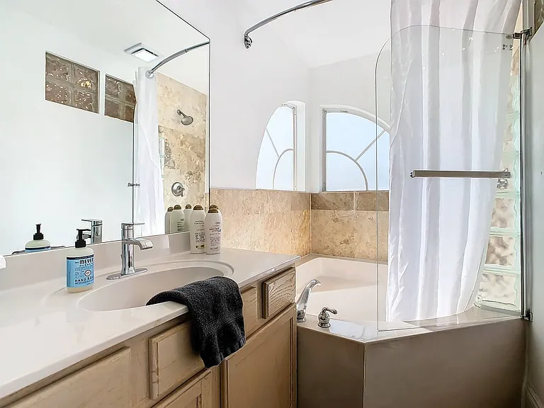Experience the luxury of a Jacuzzi tub and shower combo, enhancing your stay with lavish amenities.