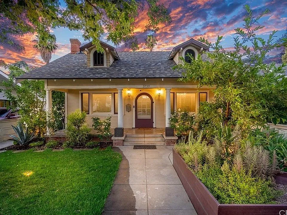 Beautiful front yard with porch and mature landscaping
