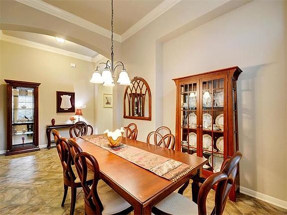 The formal dining room has crown molding, arched entry and niche perfect for a buffet.