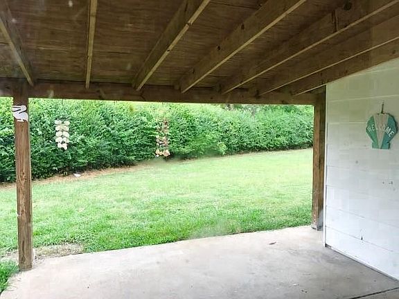 Backyard entrance to home from driveway w/walk path. 