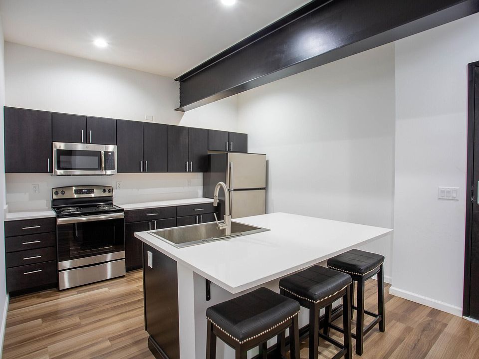 Kitchen with Spanish quartz countertops and GE appliances.