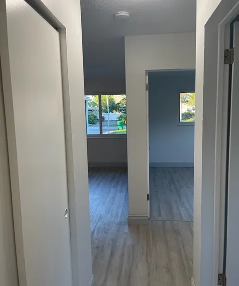 Looking down hall from shared bathroom