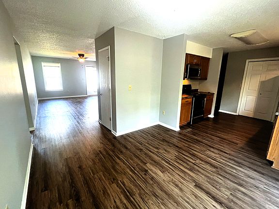 DINING AREA LOOKING AT LIVING ROOM, KITCHEN, AND HALL CLOSET