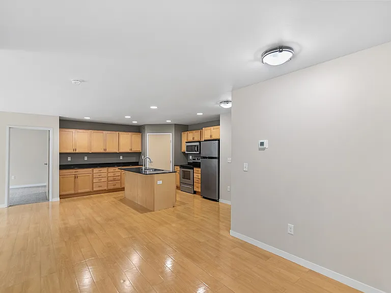 Embrace modern living at Overlook Ridge with this spacious, open-concept kitchen featuring sleek countertops and warm wood cabinetry. Enjoy convenient amenities and stylish interiors. Schedule your tour today to see your new home!