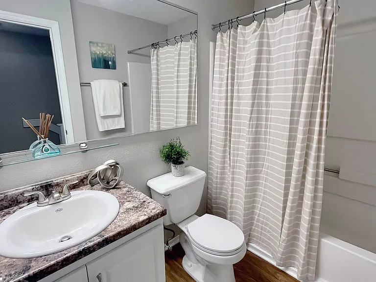 Spacious master bath boasting ample storage space and brilliant oversized mirrors.