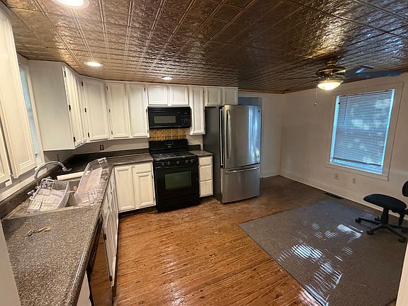 Kitchen with hardwood floors, tin ceiling