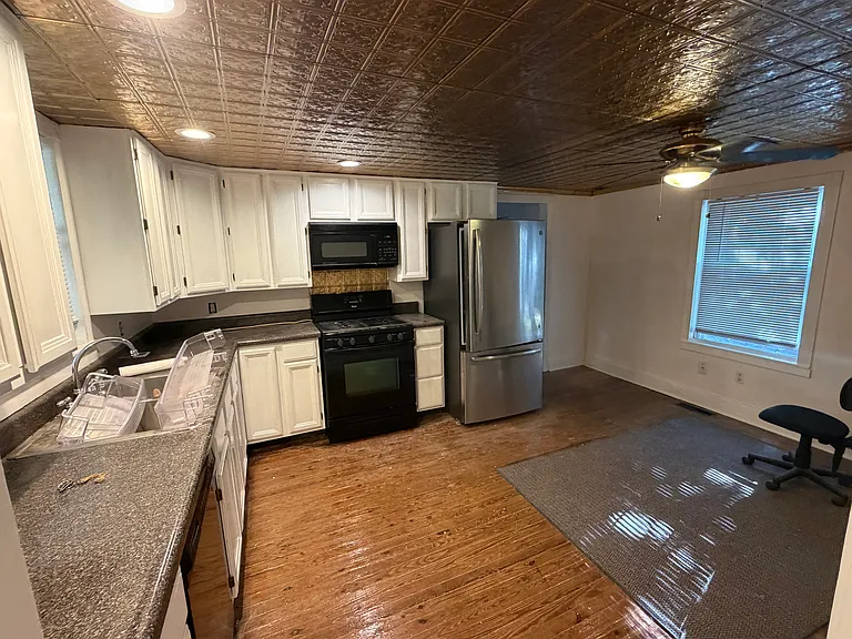 Kitchen with hardwood floors, tin ceiling
