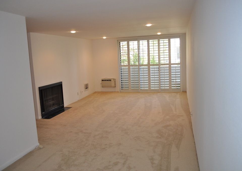 Living Room with Fireplace and Plantation Shutters