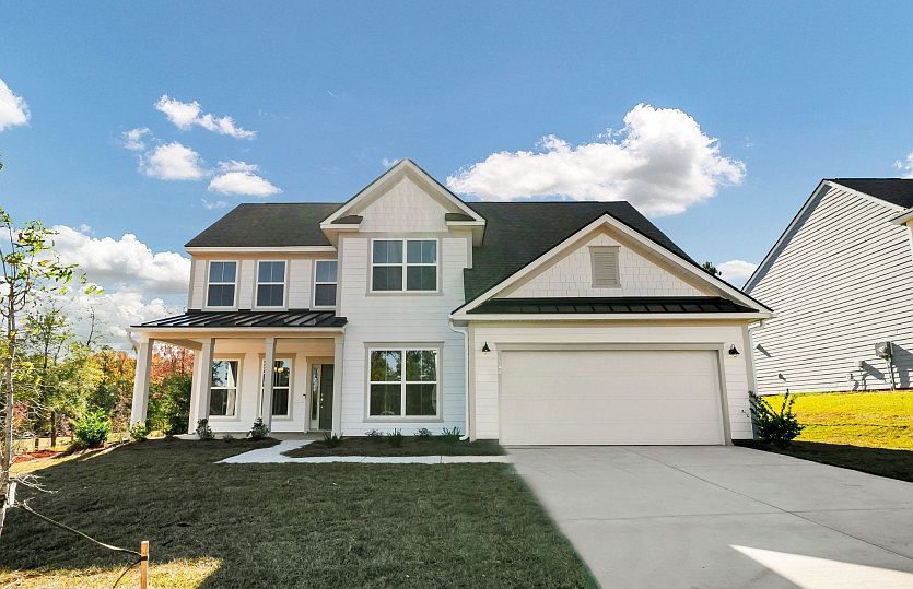 Vanderbilt Exterior 51 at Twilight with a front porch and included oversized 2-car garage.